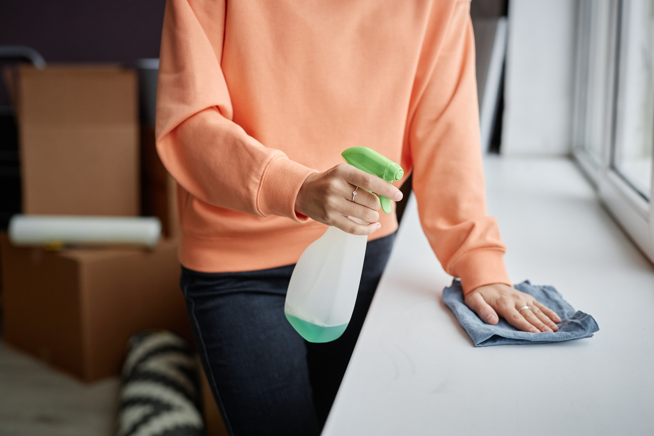 Woman using detergent to do housework